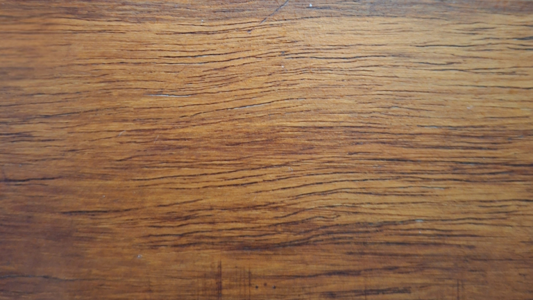 Close-up of natural wood grain, evoking craft, discernment, and grounded reflection