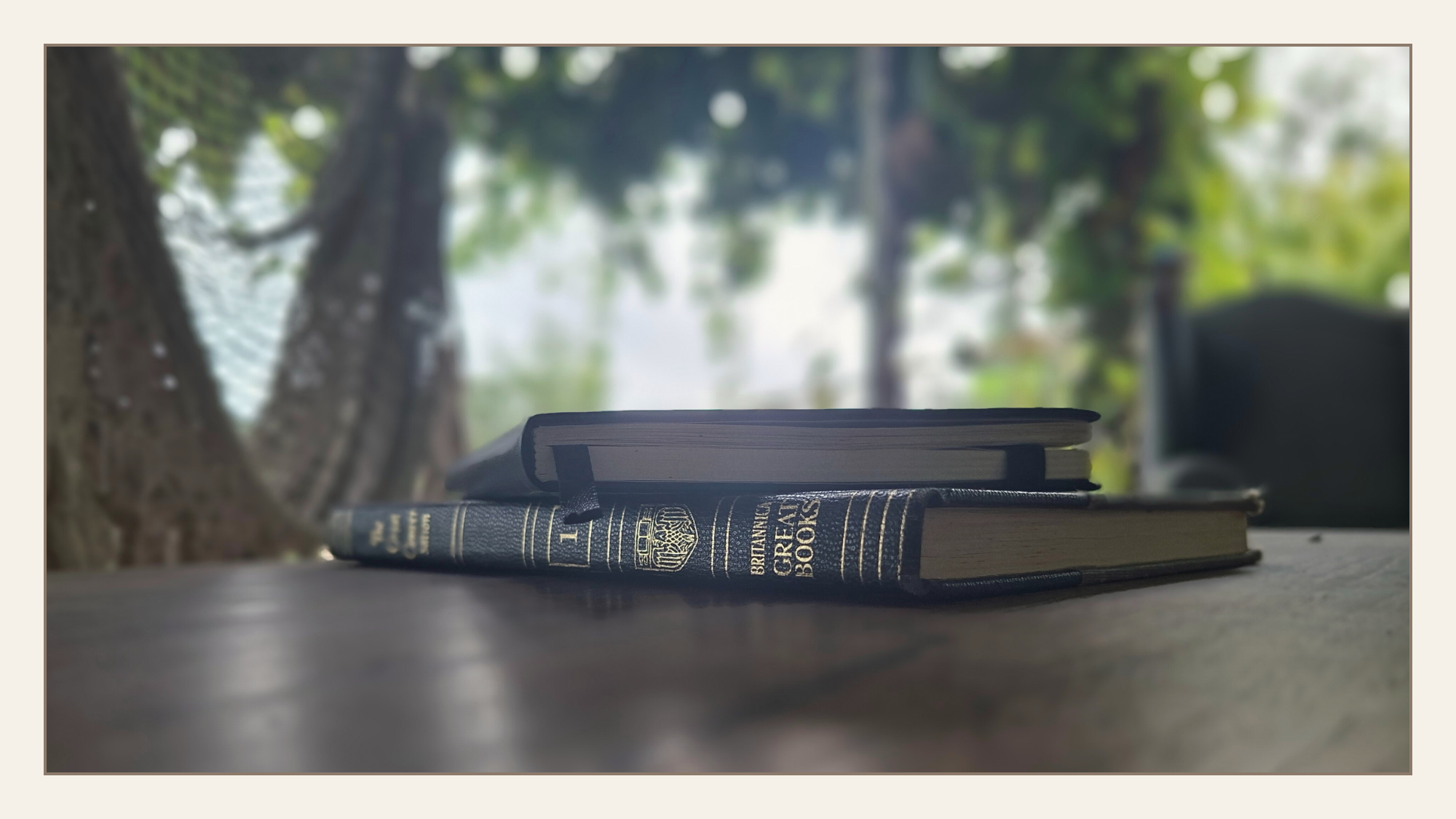 Great books on a wooden table, marking the transition from preparation to entering the Great Conversation.