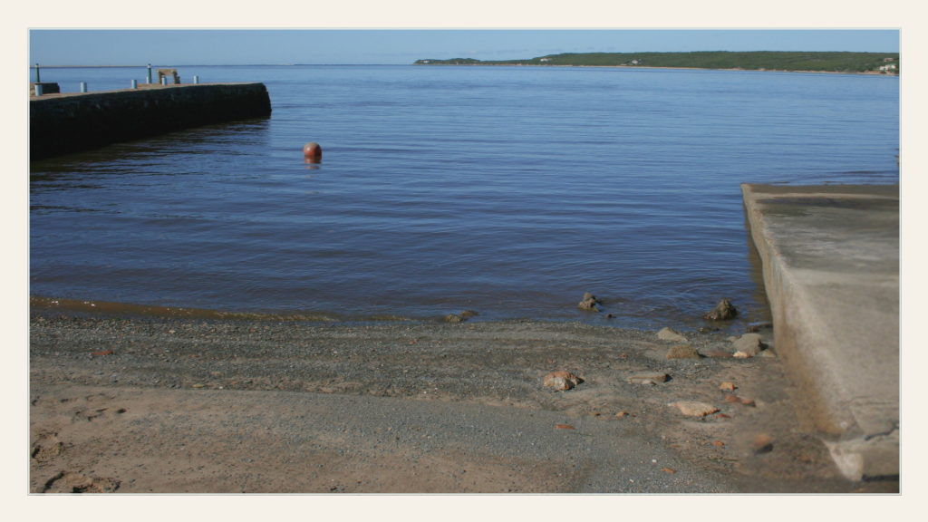 Quiet harbour with still water and open horizon, capturing a sense of space, calm, and early freedom.